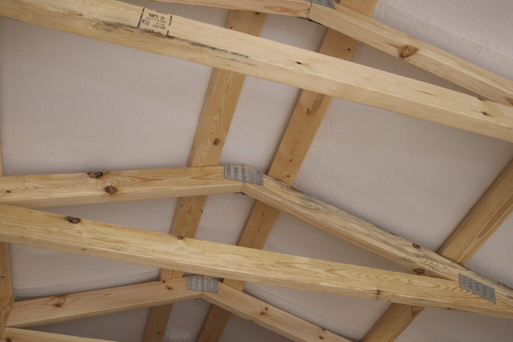 Roof trusses with bubble insulation inside a cabin style shed