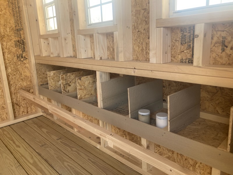 Nesting boxes with dividers inside a chicken coop