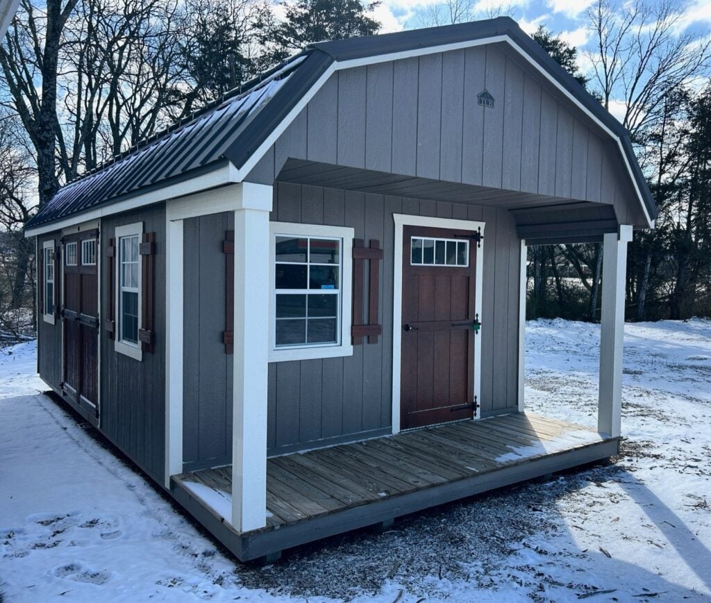 Cabin with a covered front porch and windows